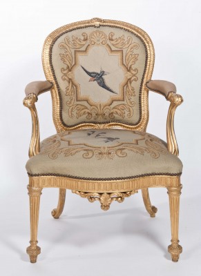 Delicate gold decorates this restored open arm chair