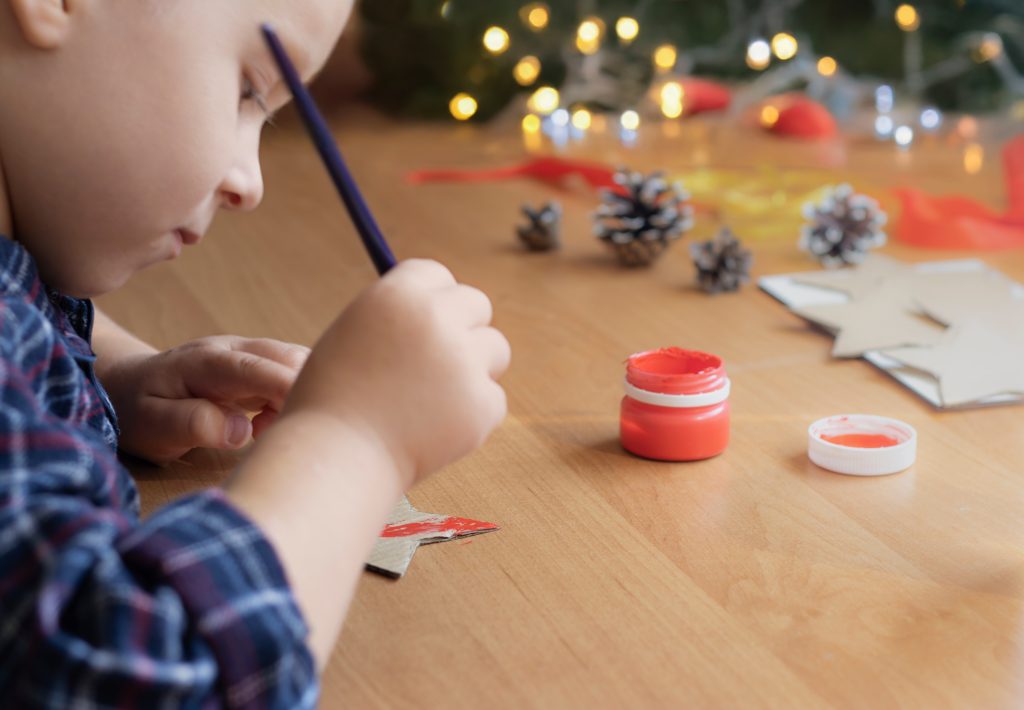 young boy makes decorations for Christmas. DIY Christmas decorations