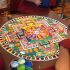 A large multicoloured sand mandala surrounded by Tashi Lhunpo monks